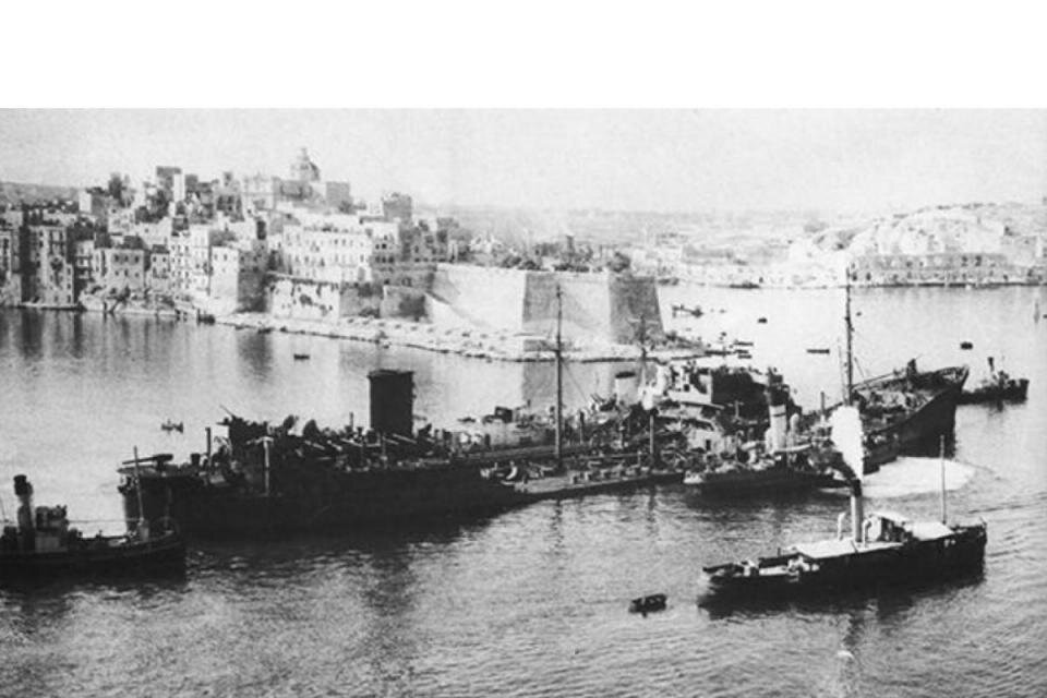 Historic wartime ships entering Malta's Grand Harbour
